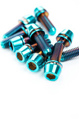 Sturdy titanium hex bolts are positioned on a snow-white background, close-up