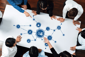 Group of professionals engaged in a collaborative discussion around a financial data visualization focused on tax strategy and business growth in a modern office environment. Amity