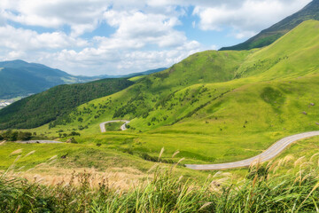 Naklejka premium Top view of silky road by Mount Yufu against blue sky, Yufuin, Oita