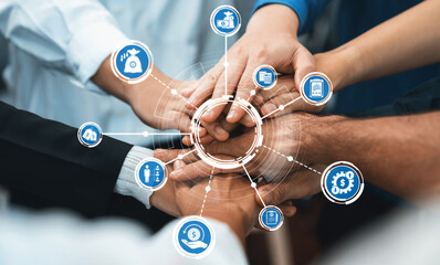 Group of diverse office worker join hand together in office room symbolize business synergy and...