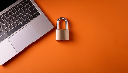 flat lay composition of cybersecurity awareness month message metallic padlock and laptop on orange background highlighting data protection and online safety themes