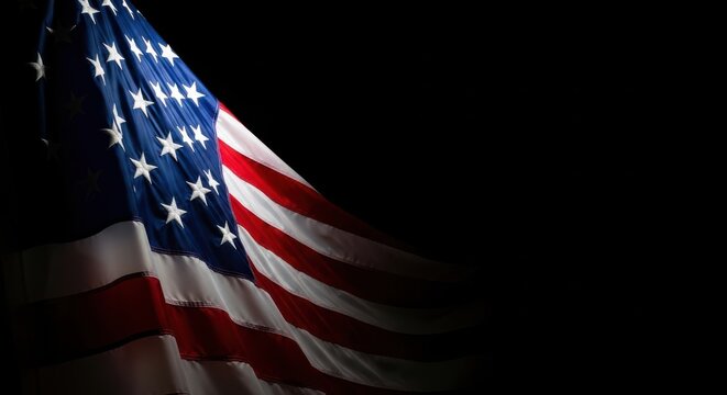 The american flag waving dramatically against a stark black background, symbolizing patriotism, freedom, and national pride with its iconic stars and stripes