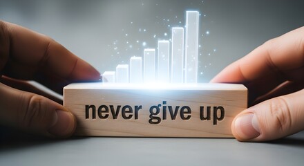 Close up of hands holding wooden block with never give up message