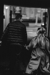 Couple walking together through an urban pathway during the evening in a stylish appearance