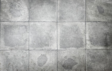 texture of gray, large square concrete tiles with damage