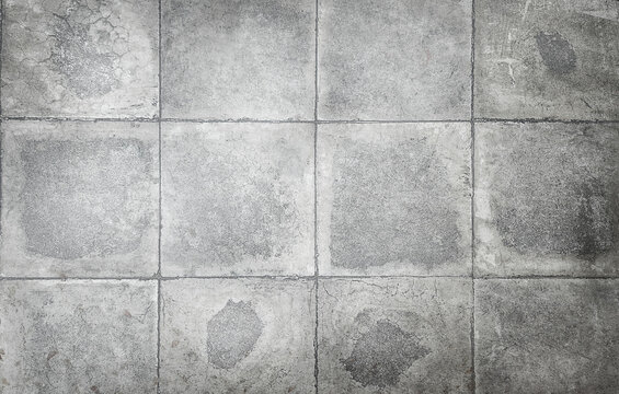 texture of gray, large square concrete tiles with damage