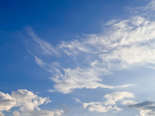 Feathery Cirrus Clouds Sweeping across Clear Blue Sky