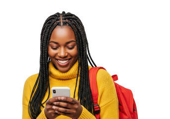 Young african american woman with braids wearing a yellow turtleneck and red backpack holding a smartphone smiling happily isolated on transparent background