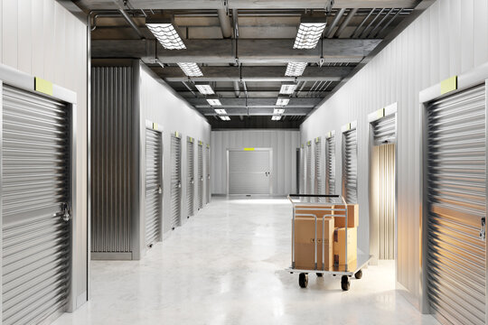 Clean, well-lit self-storage hallway with multiple metal roll-up doors, exposed ceiling pipes, and a cart loaded with cardboard boxes. Modern indoor storage facility. 3d image.