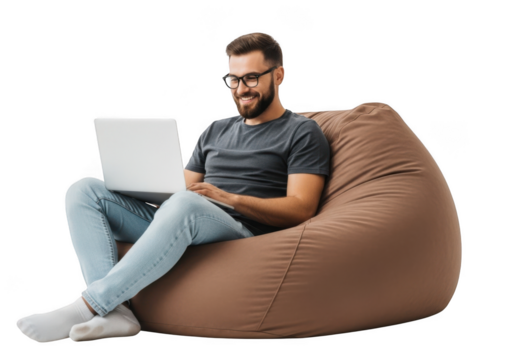 Young man with beard wearing glasses and casual clothes sitting on a large brown beanbag chair using a laptop isolated on transparent background