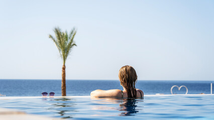 A woman in a pool by the sea will be swept on the sea