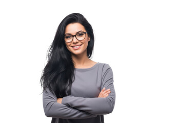 Young woman with long dark hair wearing glasses and a grey sweater smiles with arms crossed isolated on transparent background
