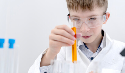 A boy conducts chemical experiments in a chemical laboratory