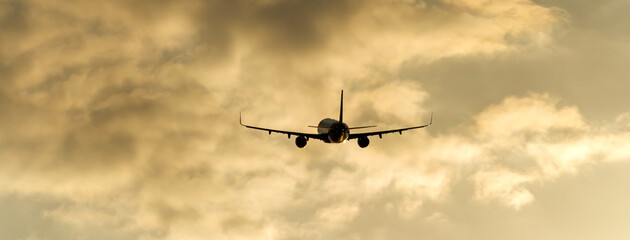 Passenger plane takes off at sunset