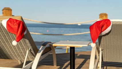 Santa hats on sun loungers by the sea