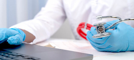Doctor with stetascope at laptop