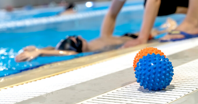 Boy learning to swim with coach in swimming pool - Powered by Adobe
