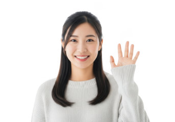 A young asian woman with long dark hair smiles warmly and raises her hand in a friendly wave isolated on transparent background