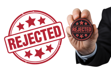 Professional businessman holding a rejected stamp, symbolizing denial, failure, or disapproval in business decisions or applications.