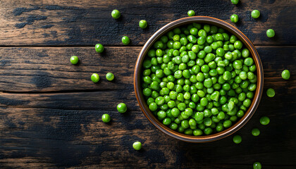 Green peas in a ceramic bowl on old wooden background