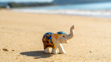Elephant figurine on the beach by the sea