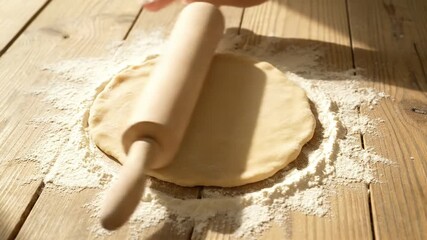 Artisan Baking Close Up of Hands Rolling Fresh Dough with a Wooden Pin on a Flour-Dusted Rustic Wooden Table Perfect for Homemade Pastries and Healthy Cooking
