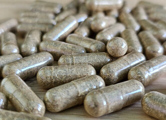 A collection of herbal capsules focusing on natural remedies and dietary supplements. Bitter herbs for colon cleansing, worm and parasite control, vitamins, and health benefits concept