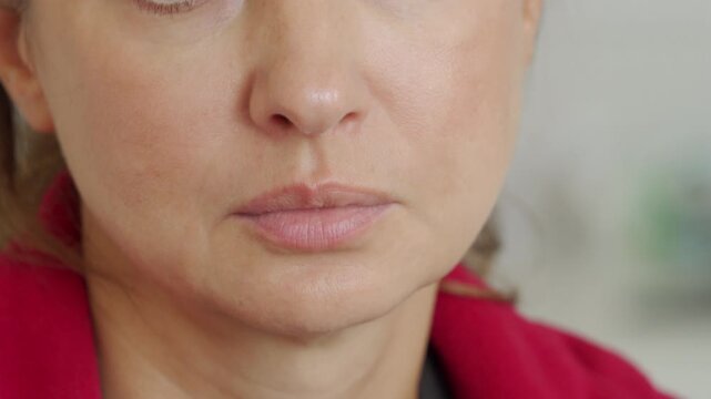 Human nose and face. Woman breathes through her nose frequently and sniffles repeatedly. Heavy nasal breathing and sharp sniffling sounds are clearly heard.