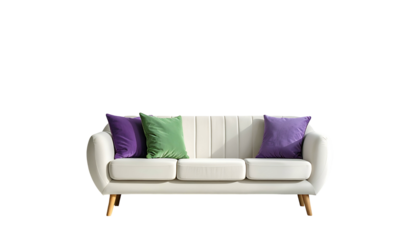 Cream-colored couch with colorful pillows against a black backdrop, lit by natural sunlight