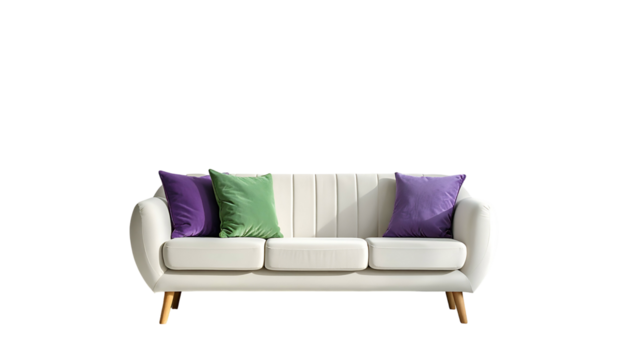 Cream-colored couch with colorful pillows against a black backdrop, lit by natural sunlight