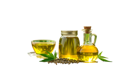 A glass teacup, a jar, & a bottle of golden liquid with seeds & leaves