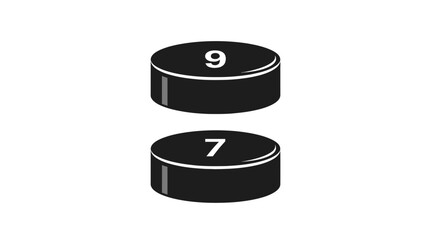 Black pucks with numbers nine and seven on white background
