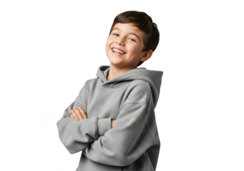 A happy young boy with dark hair wearing a grey hooded sweatshirt smiles with his arms crossed isolated on transparent background