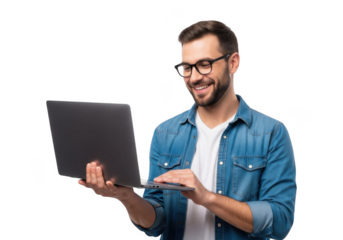 Smiling man wearing glasses and a denim shirt holding a laptop and typing isolated on transparent background