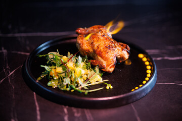 Roasted Chicken Leg Plate with Fresh Greens and Sauces on Dark Marble