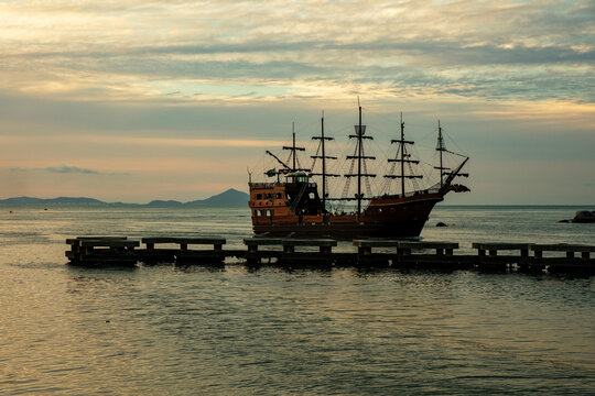 View of a caravel, an old tourist boat, at sunset on the beach in the city of Balneario Camboriu, Santa Catarina, Brazil.