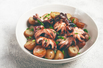 baby grilled octopus with golden baked potatoes and fresh herbs, Maltese cuisine, homemade, no people,