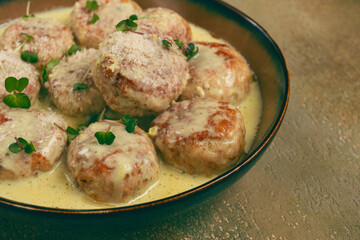 chicken meatballs, in cream sauce, garnished with parmesan cheese, and microgreens, homemade, no people,