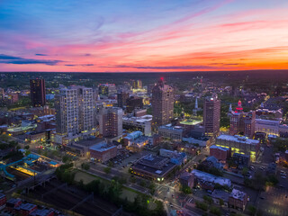 The dramatic twilight sky drapes the New Haven, Connecticut, skyline in deep blue and orange hues as city lights illuminate the scene. © Greg Boivin