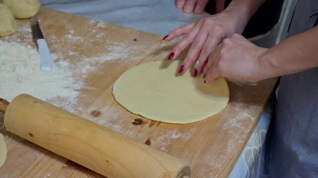 Kneaded flour cut on a wooden board