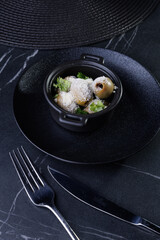 Gourmet Olive Appetizer In Black Ceramic Pot With Parsley Garnish