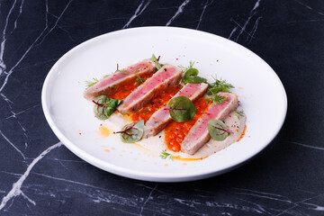 Seared Tuna Steak Slices on Creamy Sauce with Fresh Greens