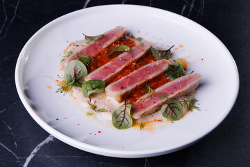 Seared Tuna Steak Slices on Creamy Sauce with Fresh Greens