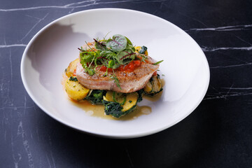 Gourmet Pork With Potatoes and Fresh Greens Plated