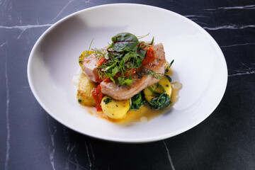 Gourmet Pork With Potatoes and Fresh Greens Plated