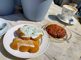 Enjoy coffee and cookies on a sunny wooden table