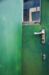 green metal door of an old vintage passenger train cabin