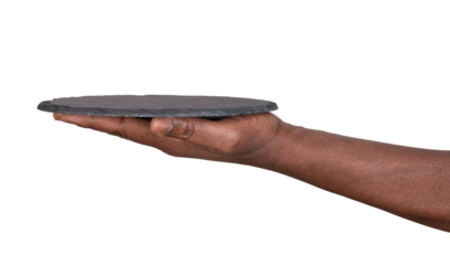 Hand holding a round stone slate plate or a tray isolated on white or transparent background 