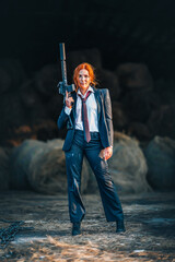 Redhead woman in a suit with a rifle