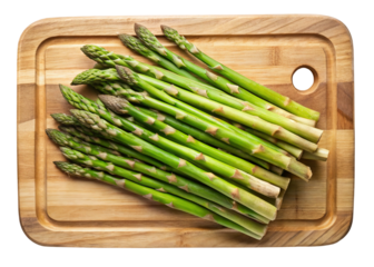 Fresh green asparagus spears arranged on a wooden cutting board isolated on transparent background